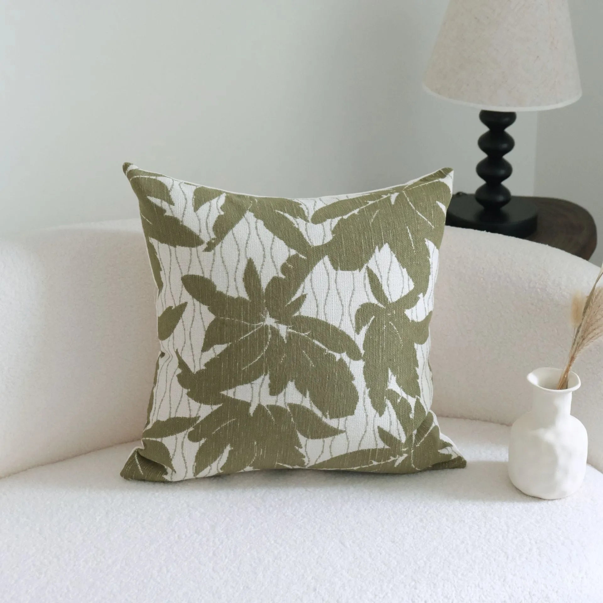 Green striped and botanical patterned cotton linen decorative pillow with tassel detail.