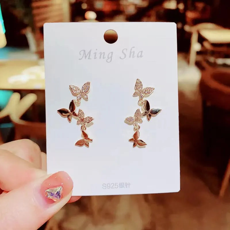 Women's gold colour copper butterfly drop earrings with four-butterfly design