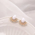 Silver fan-shaped geometric stud earrings with rhinestone detailing on white background