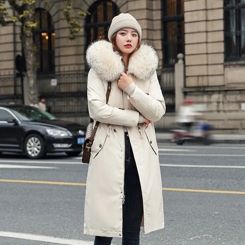 Women's white cotton-padded trench coat with two-way zip showing extended 100cm length and long sleeves