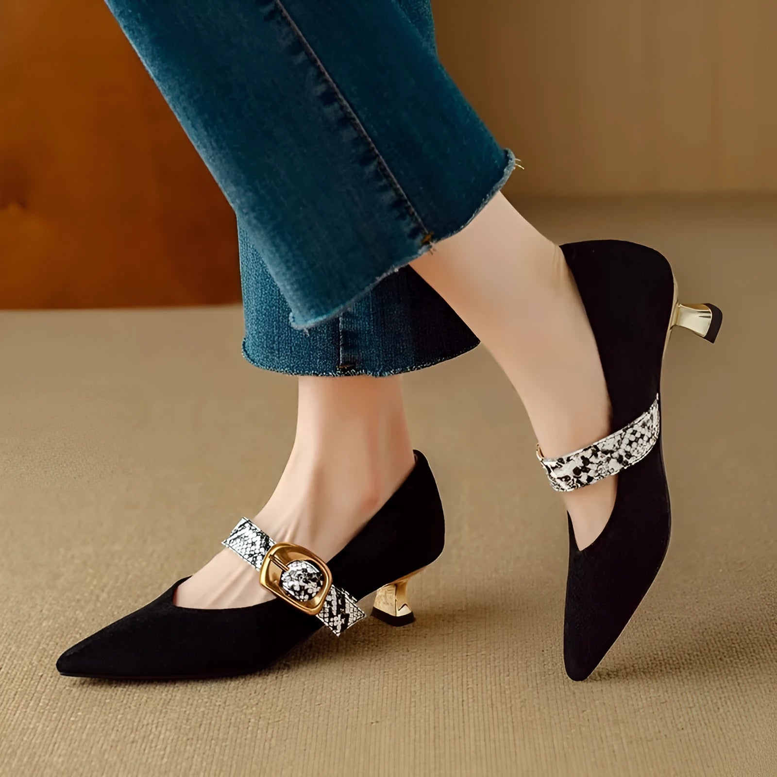 Black women's pointed toe stiletto high heels with a buckle fastening across the instep.