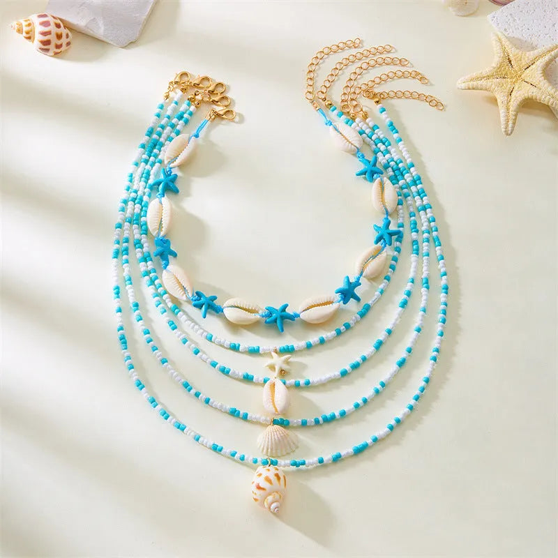 Women's multi-layer necklace set with starfish, shell and conch bead pendants in blue