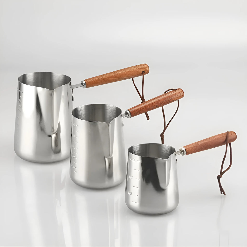 Stainless steel milk jug with wooden handle for latte art, shown in 350ml, 600ml and 1000ml sizes.