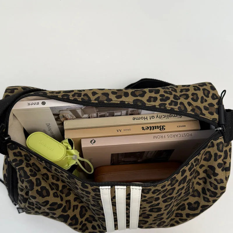 Leopard print sports style messenger bag with cross-body strap and decorative stitching