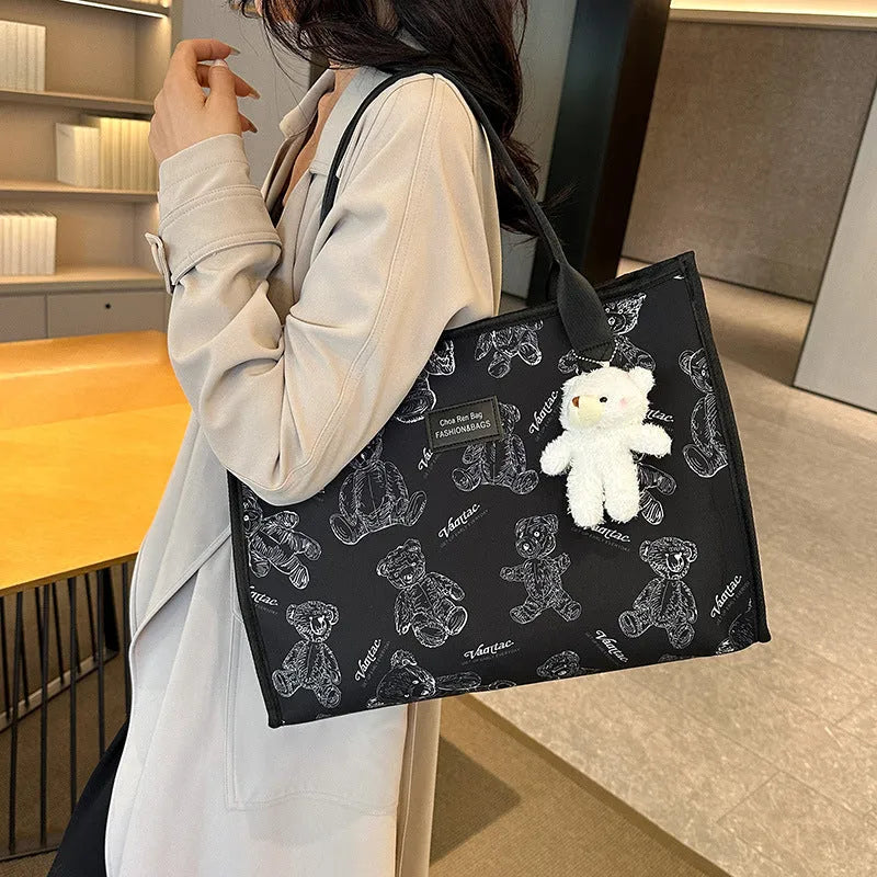 Women's printed canvas tote bag with diamond pattern, sandwich pocket, and shoulder strap