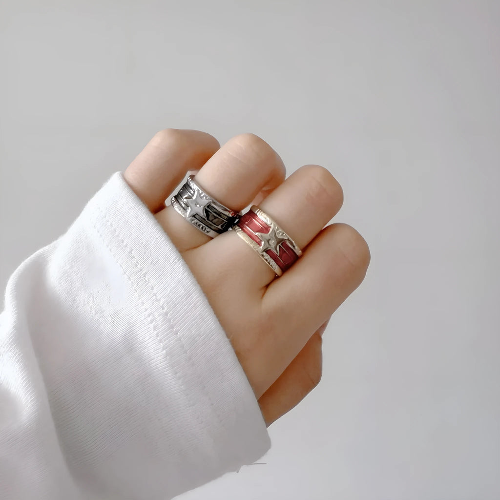 Adjustable geometric drop oil ring in distressed electroplated copper on a hand.