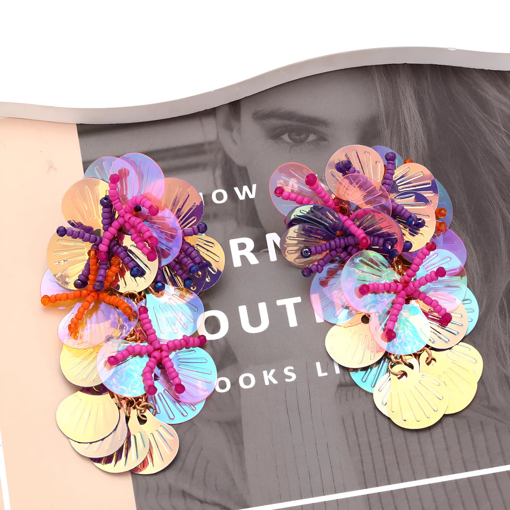 Women's exaggerated handmade string bead floral earrings in mixed materials, showing colourful, rose, and purple colour options.
