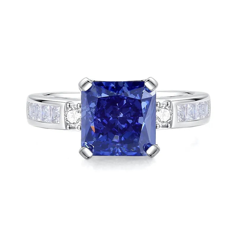 Heart-shaped 925 sterling silver ring with a sparkling ice flower cut colour zircon stone on a finger.