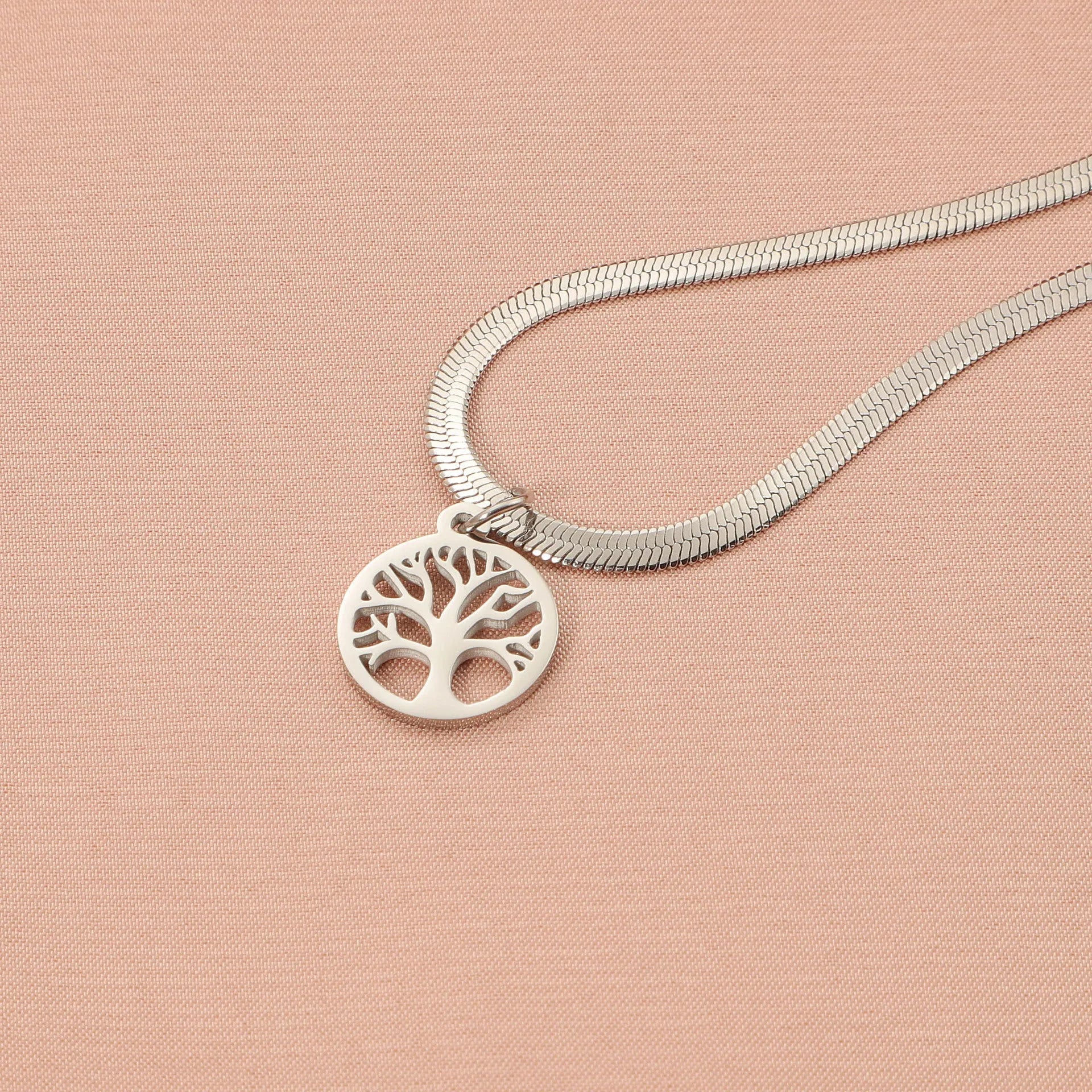 Stainless steel lucky tree necklace on snake bones chain, shown in gold and steel colour finishes.