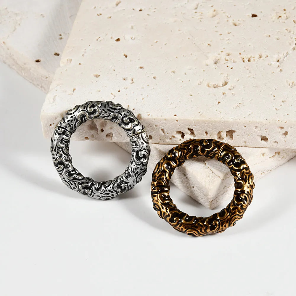 Fashion stainless steel earrings with a shaped totem pattern in an electroplated colour finish.
