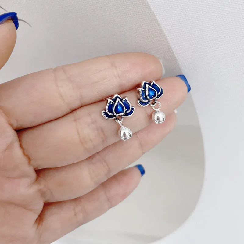 Blue alloy lotus earrings with seedpod tassel detail, showing floral stud design.