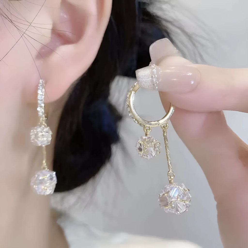 Silver-colour women's clip-on earrings with a confession balloon design, rhinestone ball, and double tassel pendant.