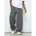 Men's straight-leg casual trousers in polyester fabric with drawstring waist in solid colour options