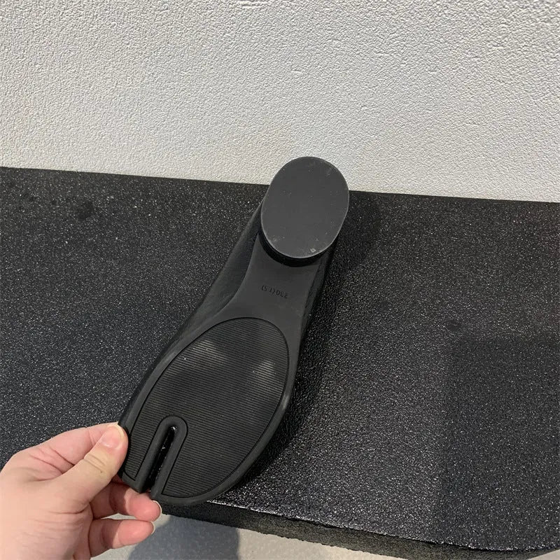 Women's black chunky heel pumps with a unique split toe horseshoe peas design and a low rubber sole.