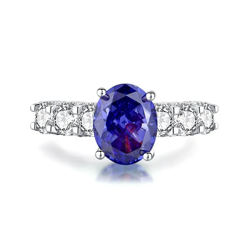 Heart-shaped 925 sterling silver ring with a sparkling ice flower cut colour zircon stone on a finger.