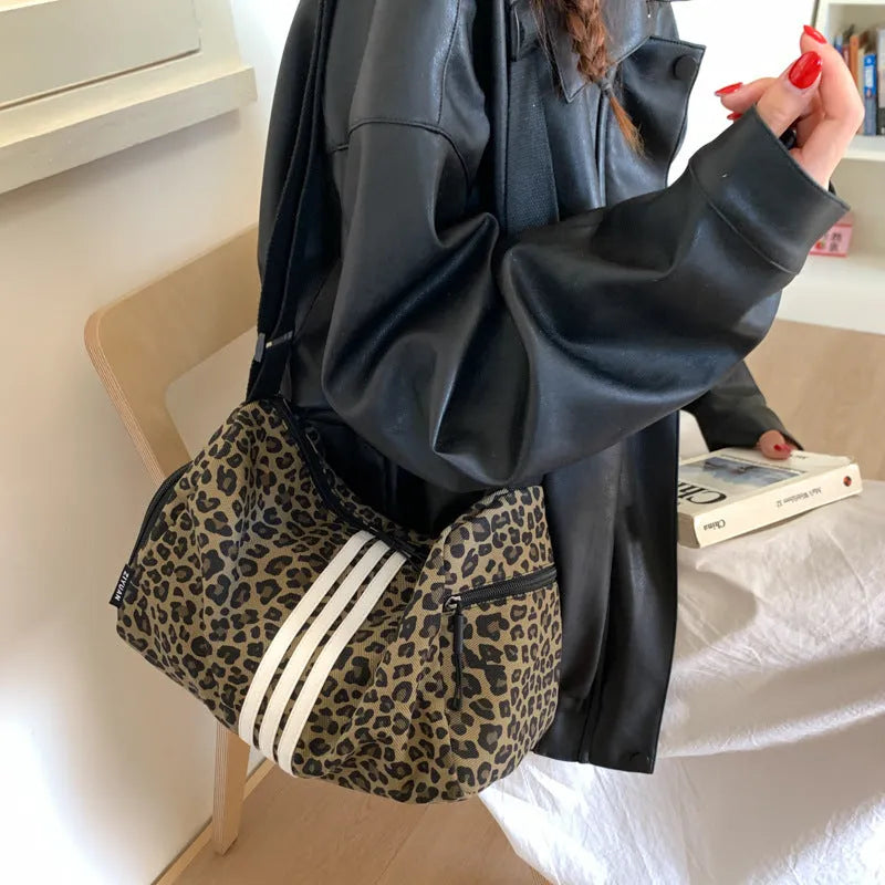 Leopard print sports style messenger bag with cross-body strap and decorative stitching