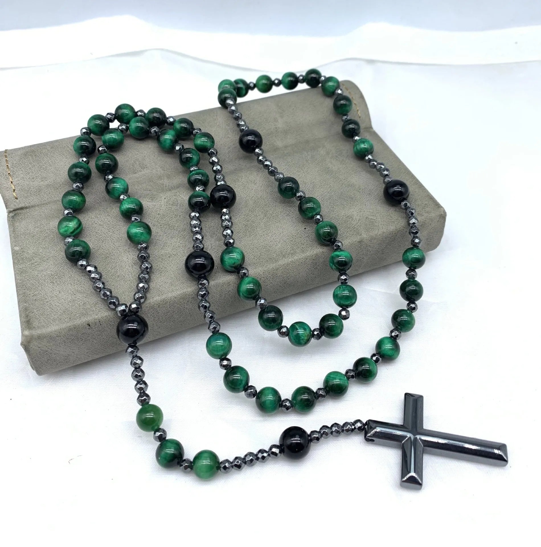 Men's hand-woven stone cross pendant necklace on a ball bead chain with safety lock clasp.