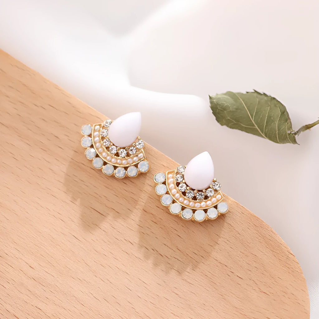Silver fan-shaped geometric stud earrings with rhinestone detailing on white background