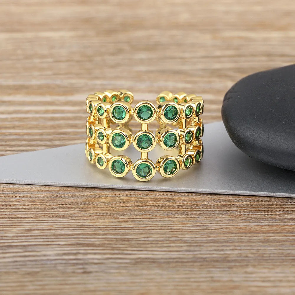 Copper ring with 18K gold plating and green zircon on exaggerated wide three-layer band