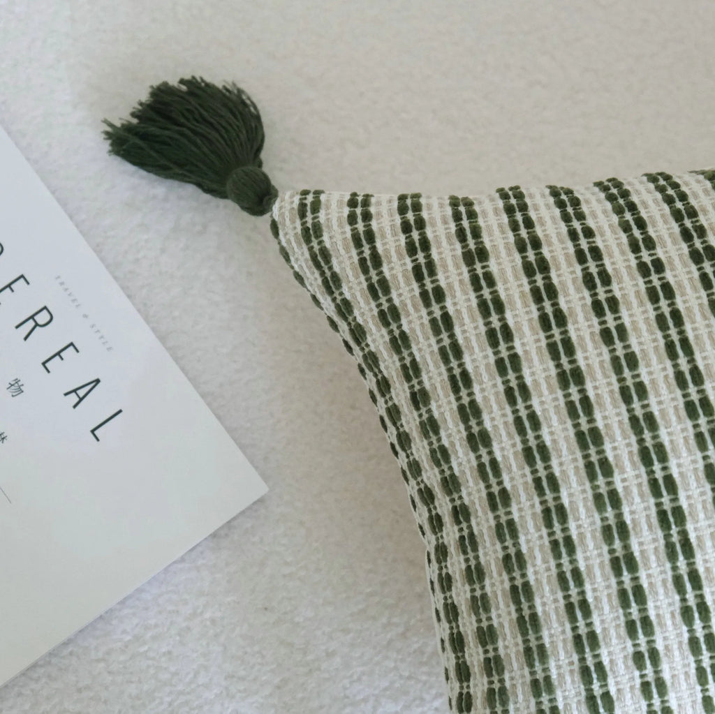 Green striped and botanical patterned cotton linen decorative pillow with tassel detail.
