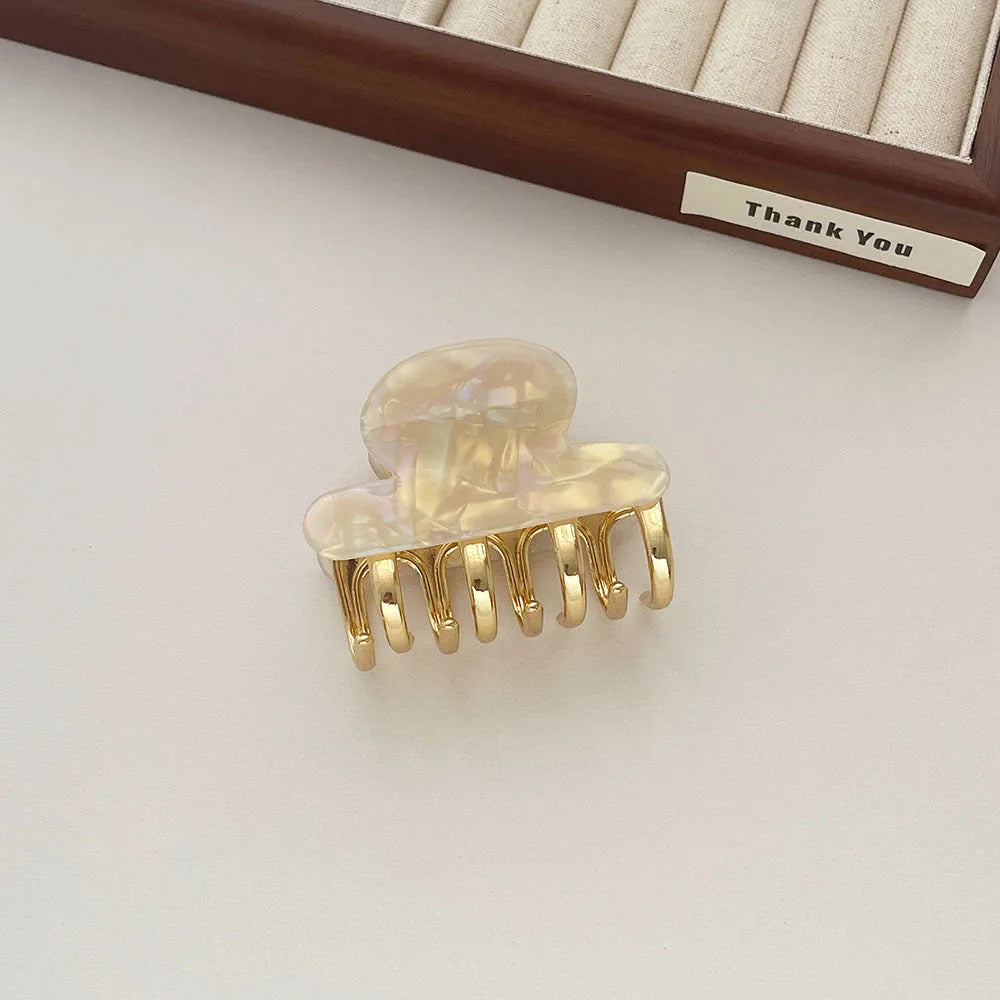 Dopamine retro acetate hair barrette with a metal grip in a medium size, shown in beige colour.