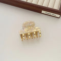 Dopamine retro acetate hair barrette with a metal grip in a medium size, shown in beige colour.
