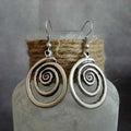 Silver geometric spiral distressed earrings measuring 2.6cm by 5cm with alloy construction