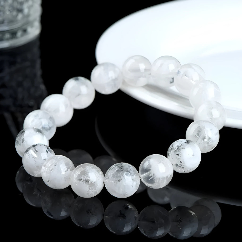 Natural blizzard snowflake crystal bracelet with round beads showing Ruyi and Xiangyun design elements