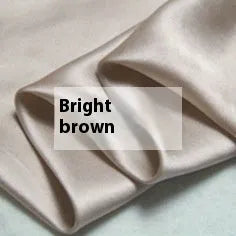 Solid colour silk duvet cover laid flat, showing double-sided construction and smooth texture.