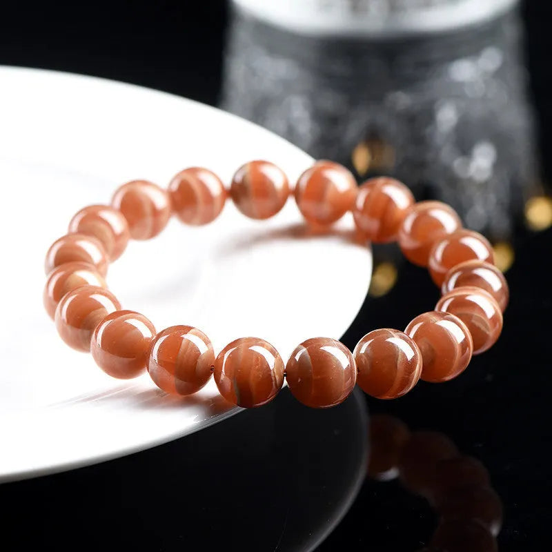 Natural Old Mine Rhodochrosite round beads bracelet from Peru showing manganese spar mineral colour