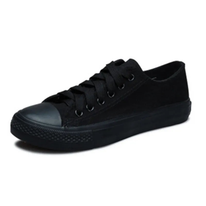 Women's solid colour canvas casual flat shoes on a plain background.