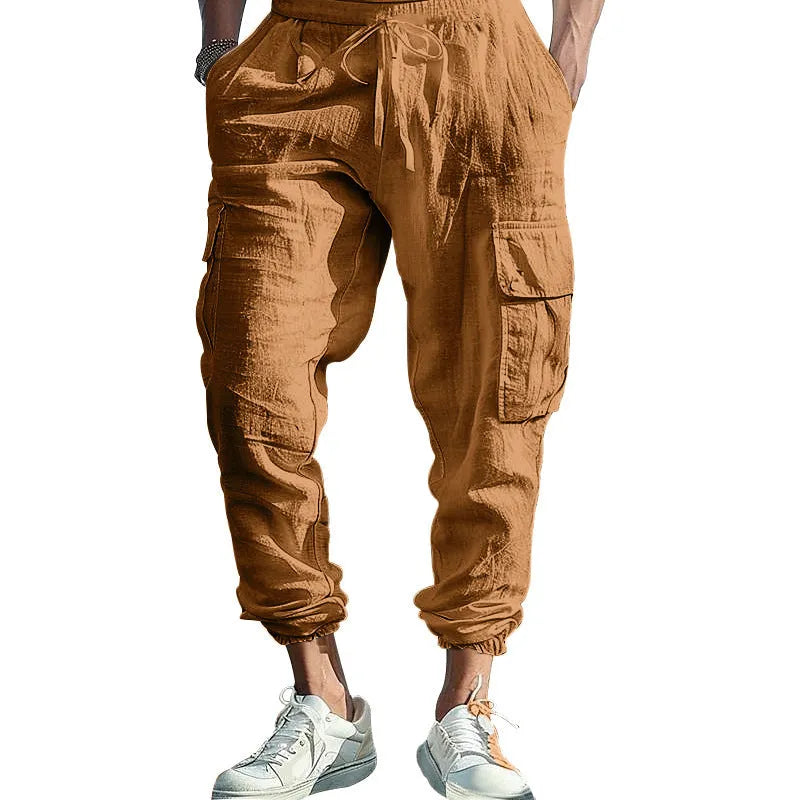 Men's solid colour linen casual trousers with ankle ties and drawstring waist on hanger.