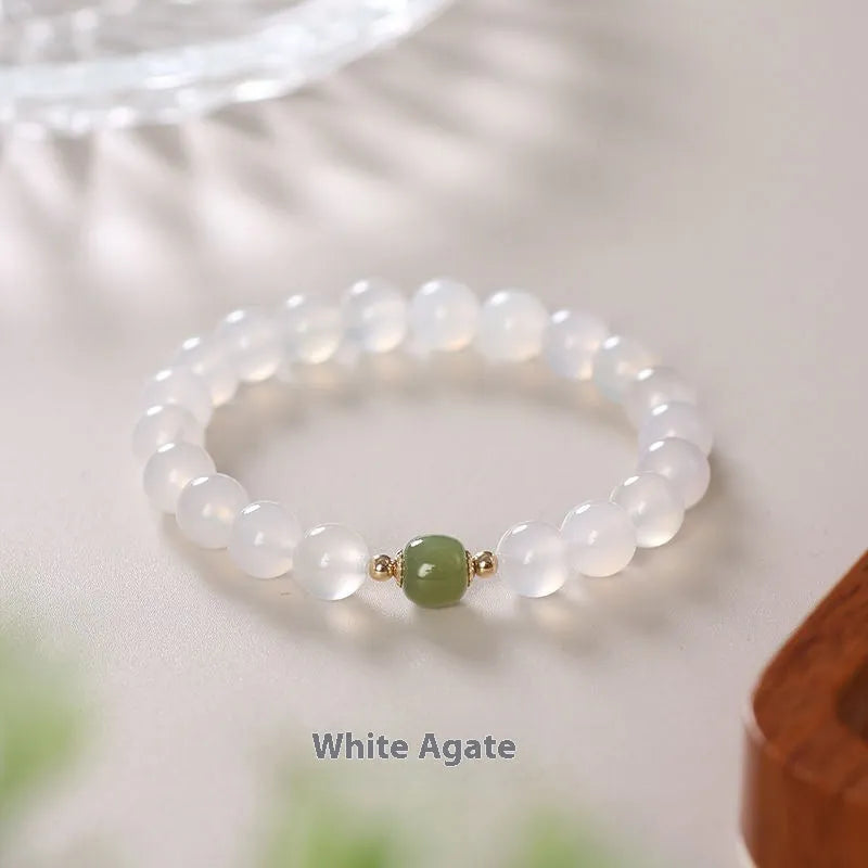 Handmade white agate crystal bracelet with cinnabar inlay showing 6mm and 8mm bead size options