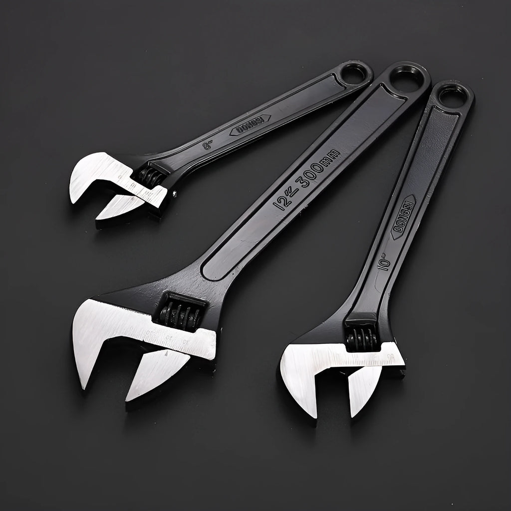 Stainless steel adjustable open-end wrench on a workbench