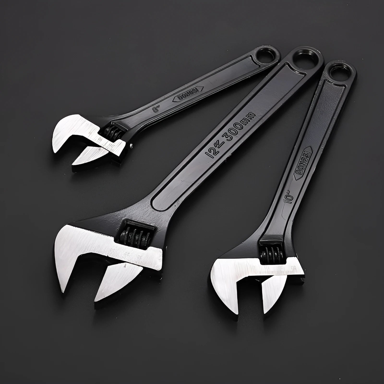 Stainless steel adjustable open-end wrench on a workbench
