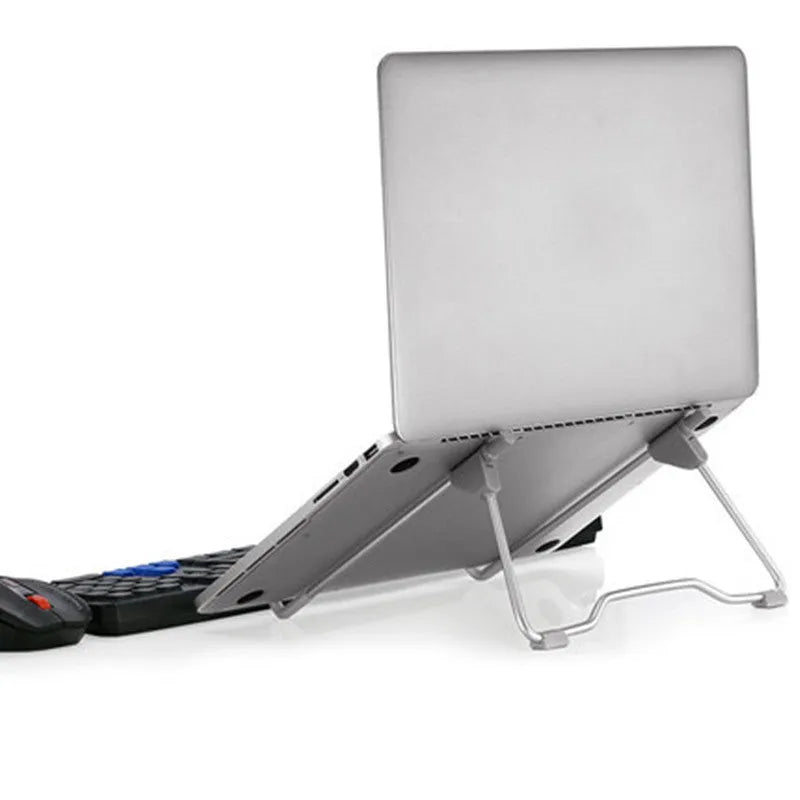 Grey aluminium alloy and plastic desktop stand holding a mobile phone and a laptop.