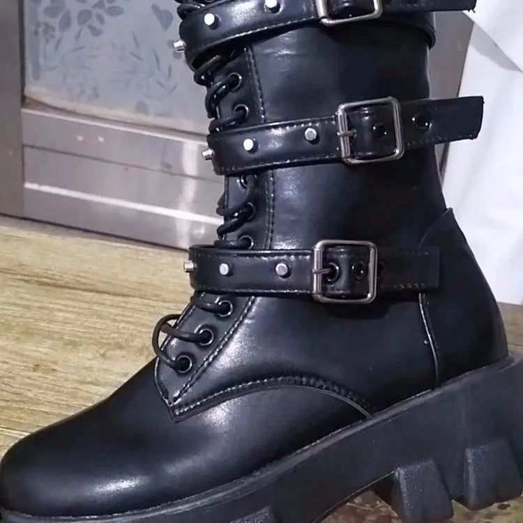 Women's black mid-calf boots with metal buckle straps and a side zipper on a white background.