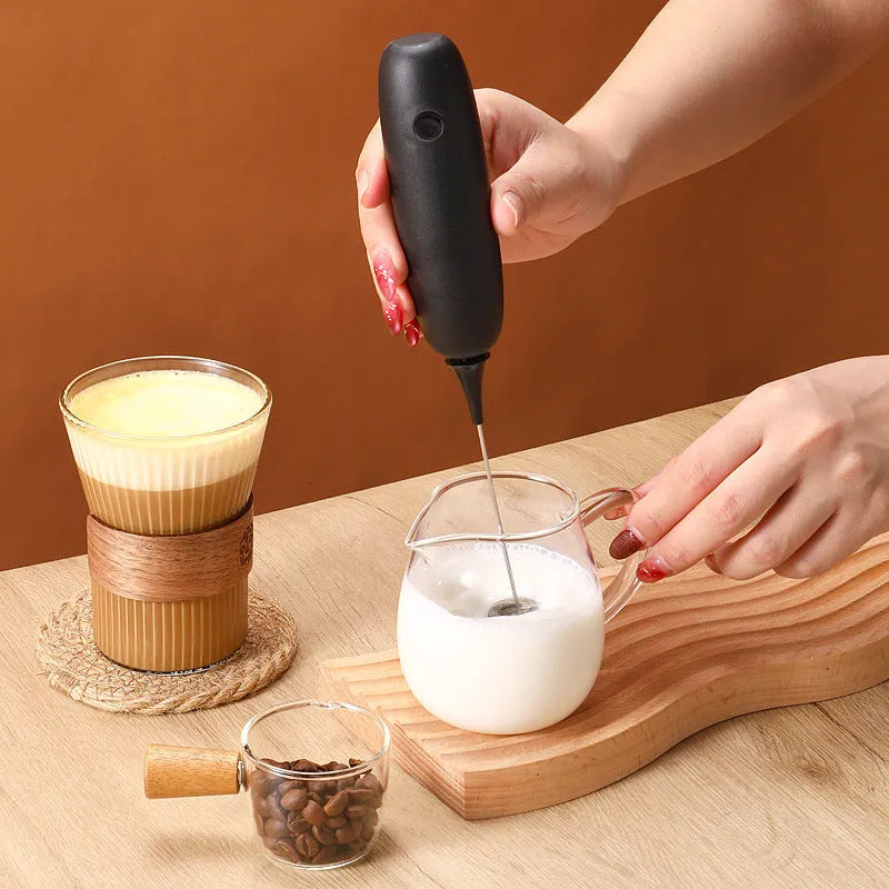 Handheld electric milk frother blender in black and white colours with frothing whisk