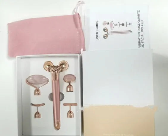 Rose gold five-in-one vibrating face lifting machine with four interchangeable jade and beauty heads in a compact box