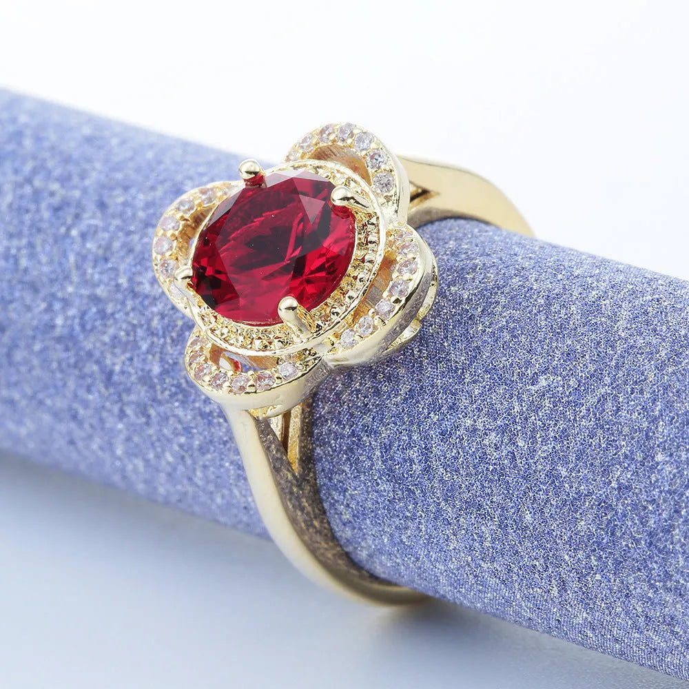 Copper fruit-shaped ring with a zircon stone inlay on a hand.