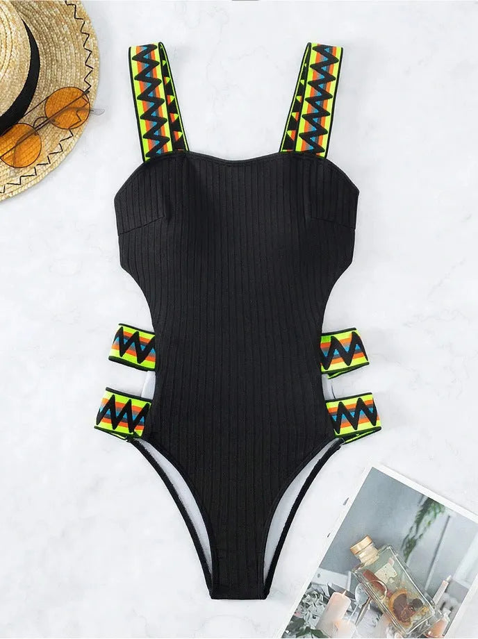 Solid colour women's one-piece bikini swimsuit in black or orange.