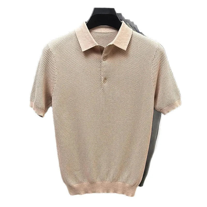 Man wearing a loose-fit grey short sleeve cotton pullover sweater for casual leisure wear.