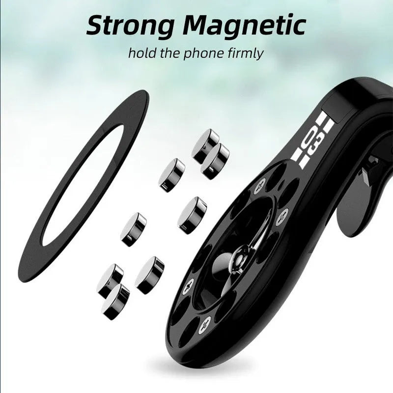Black magnetic car phone holder clipped to a car air vent, holding a mobile phone, with a fragrant slice inserted.