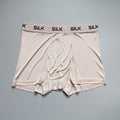 Man wearing loose-fit navy blue silk shorts with a mid waist design.