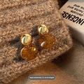 Three pairs of geometric women's earrings with tassel details in irregular, wafer, and water drop styles.