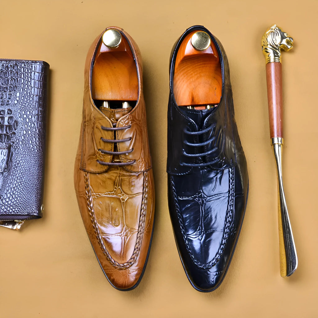 Men's black and brown British-style leather shoes with alligator grain and a horse bit buckle.