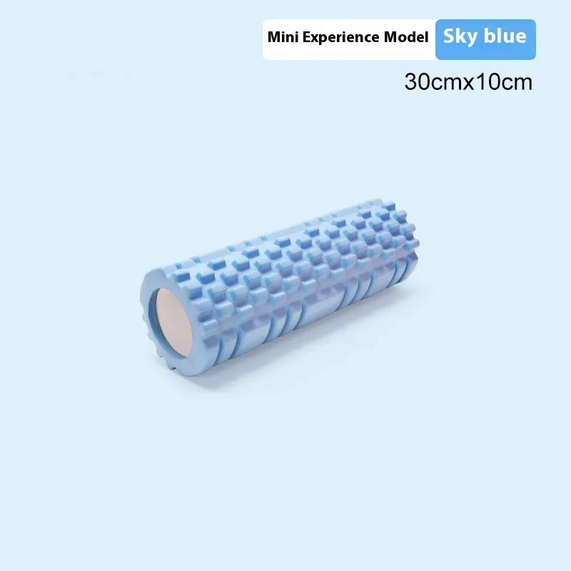 EVA foam fitness roller in black on a wooden floor, showing cylindrical shape and textured surface.