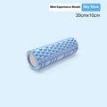 EVA foam fitness roller in black on a wooden floor, showing cylindrical shape and textured surface.