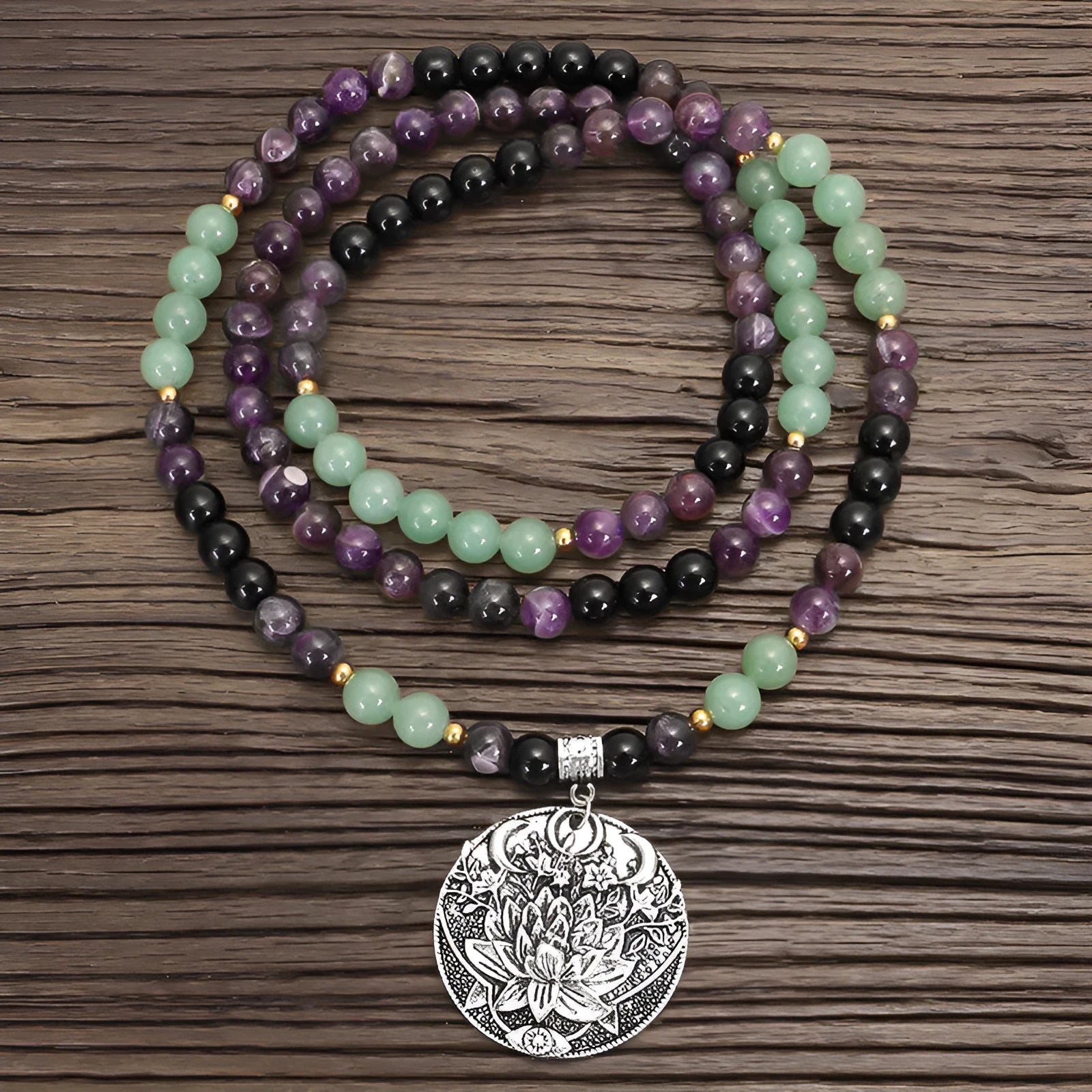 Handmade yoga necklace with lotus pendant and stone beads alongside matching bracelet