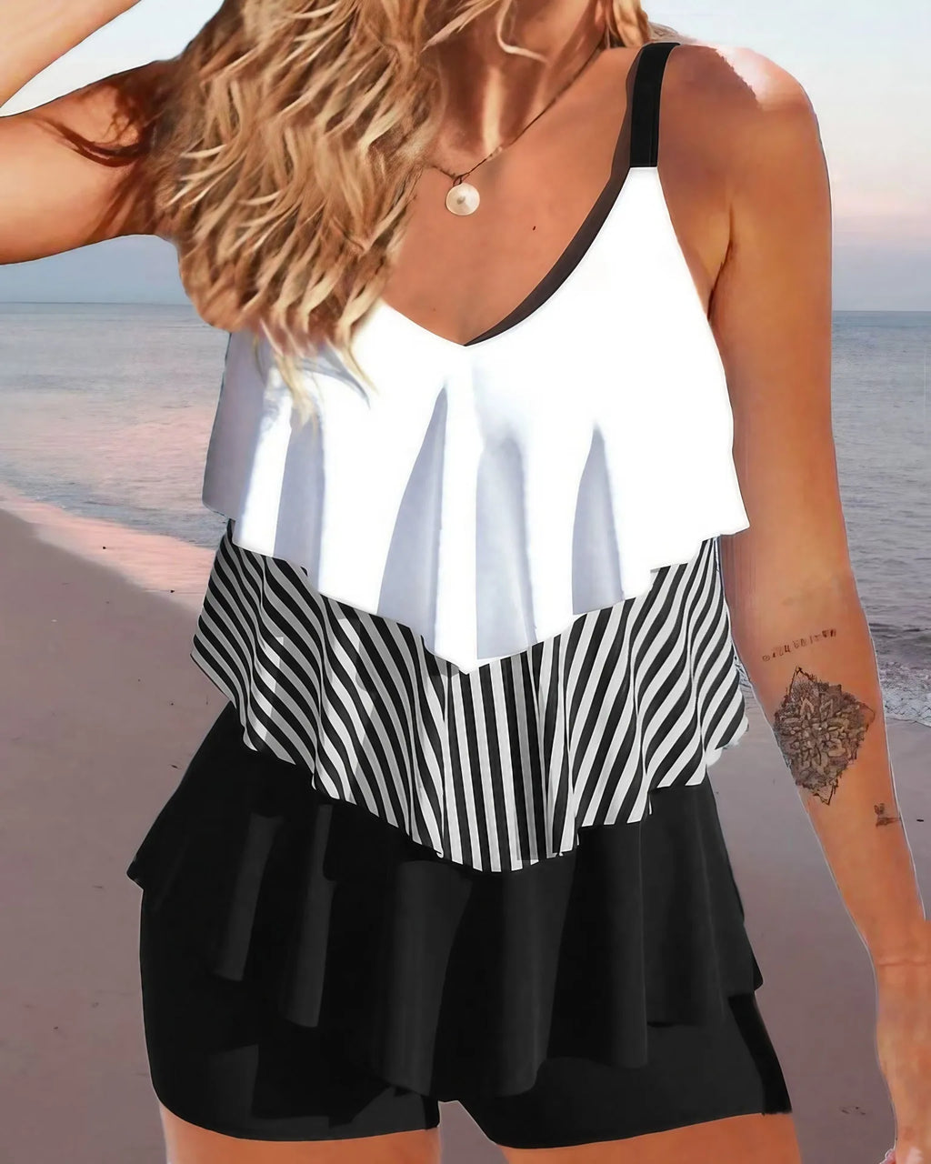 Women's sleeveless backless spaghetti strap bikini swimsuit with ruffle detail and split briefs.